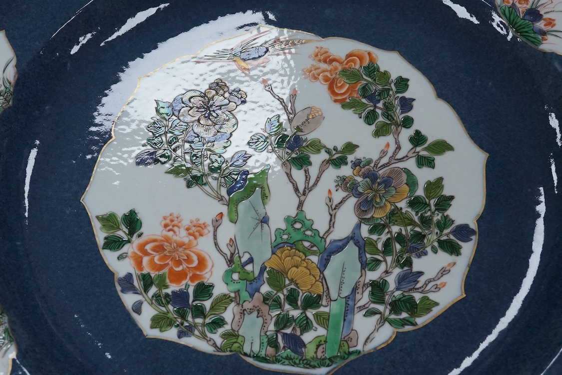 A near pair of Samson famille verte powder blue dishes in Chinese export style, each painted with a pheasant flying above blossoming branches and rocks, the border set with eight floral cartouches, underglaze blue ribbon